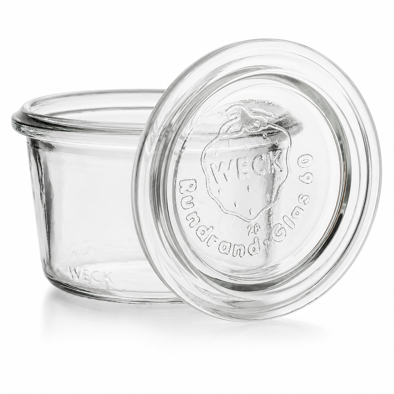 WECK-Mini-Sturzglas 80 ml RR60 aus Klarglas mit passendem Glasdeckel, Rundrandmündung und sichtbarer WECK-Prägung auf weißem Hintergrund.